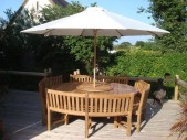 Chunky 210cm dia teak table with contour benches & parasol